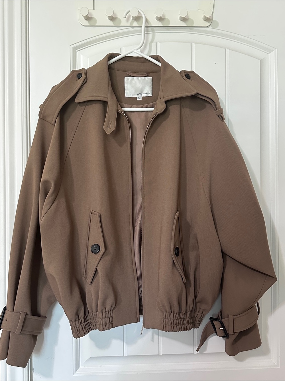 Tan bomber jacket with adjustable cuffs and waist
